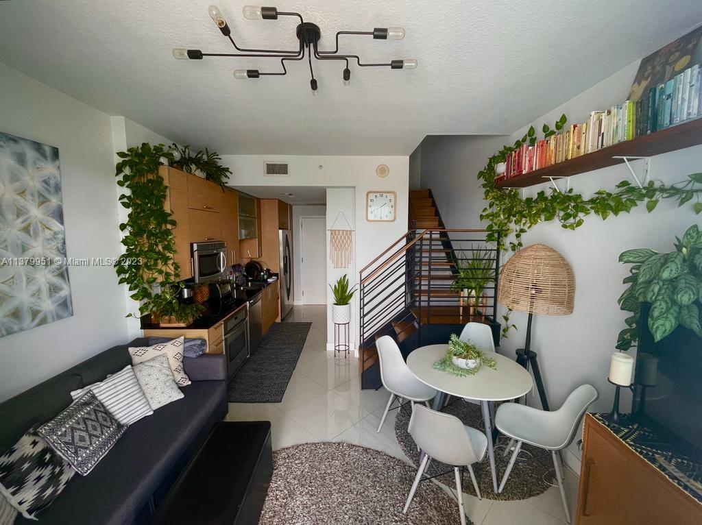 60 Southwest 13th Street, Unit 2413 Miami, FL 33130 - Photo 5 of 27 a living room with furniture and a potted plant