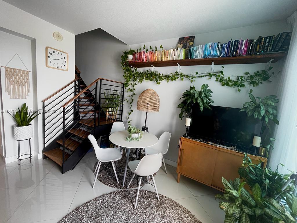 60 Southwest 13th Street, Unit 2413 Miami, FL 33130 - Photo 6 of 27 a living room with furniture and a potted plant