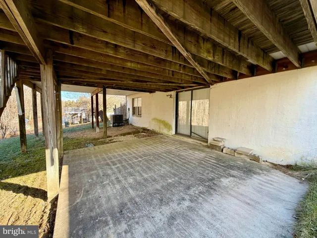 a view of large trees with wooden fence