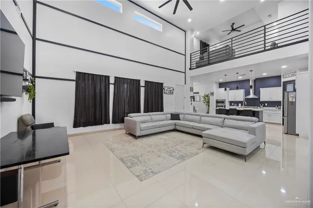 a living room with furniture and kitchen view