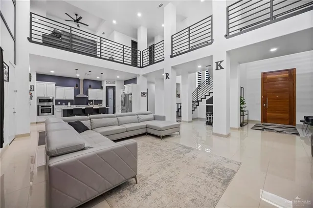 a living room with furniture and kitchen view