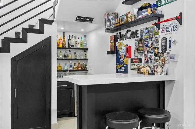 a kitchen with stainless steel appliances granite countertop a sink stove a refrigerator and a refrigerator with wooden floor