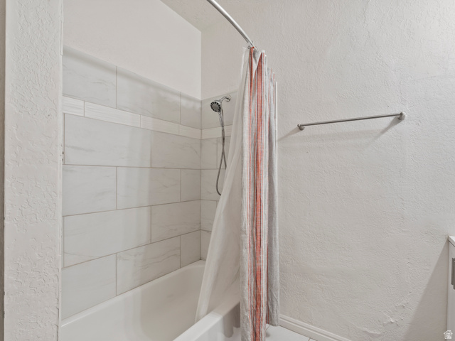 510 Canyon Road Ogden, UT 84404 - Photo 11 of 30 Bathroom with a textured wall, shower / bath combo with shower curtain, and vanity