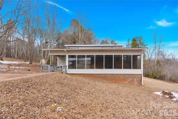 a view of a house with a backyard