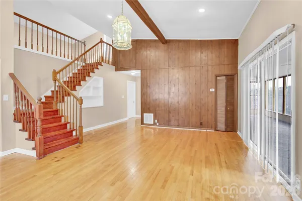 a view of entryway with wooden floor and stairs