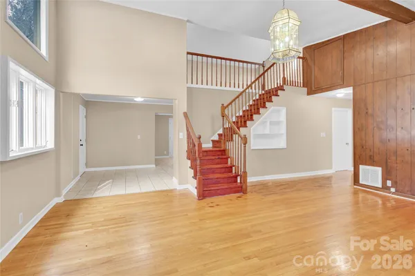 a view of entryway and hall with wooden floor
