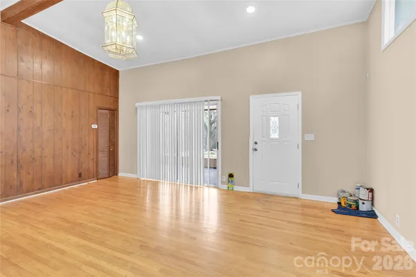 a view of an empty room with wooden floor