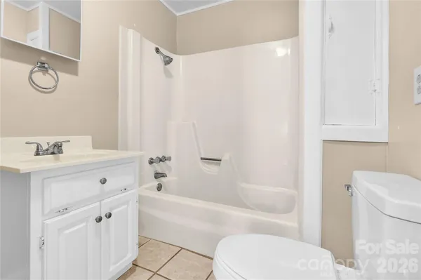 a bathroom with a bathtub toilet sink vanity and mirror