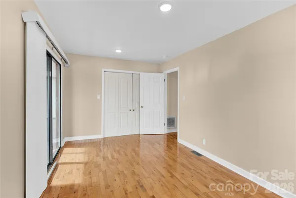 a view of hallway with wooden floor