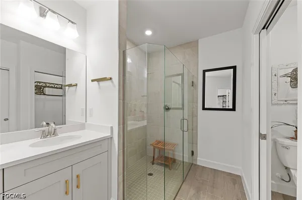 a spacious bathroom with a double vanity sink mirror and shower