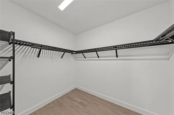 a view of a room that has a bed and a chandelier in it