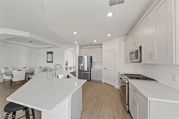a kitchen with a sink stove and cabinets