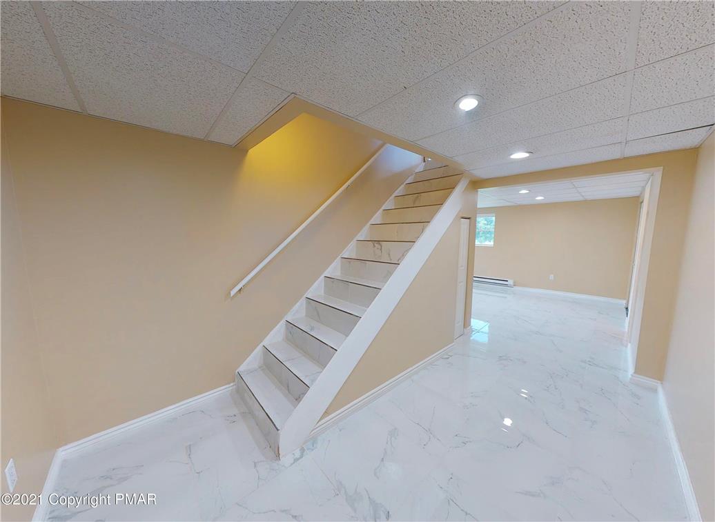 1110 Misty Ridge East Stroudsburg, PA 18302 - Photo 41 of 43 Clean, contemporary staircase provides seamless flow to a versatile lower level.