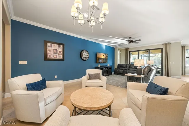 a living room with furniture a chandelier and a window