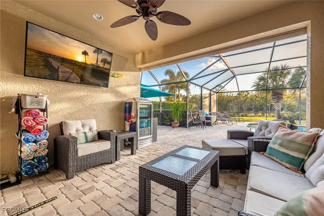 a living room with patio furniture and a floor to ceiling window