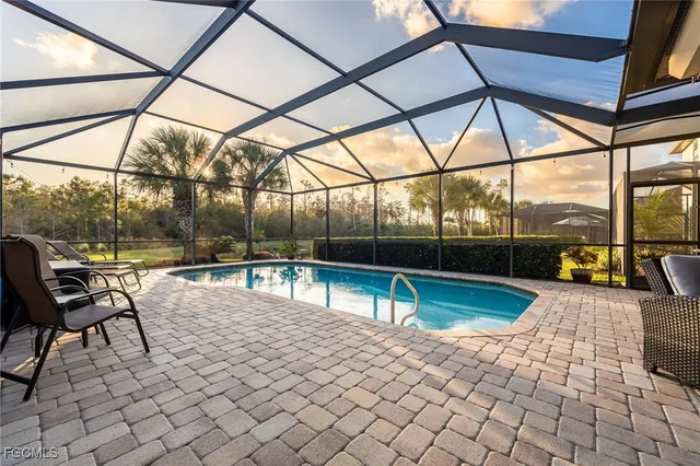 a view of a swimming pool with a lounge chair
