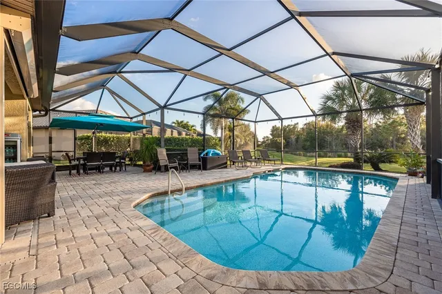 a view of a patio with table and chairs under an umbrella