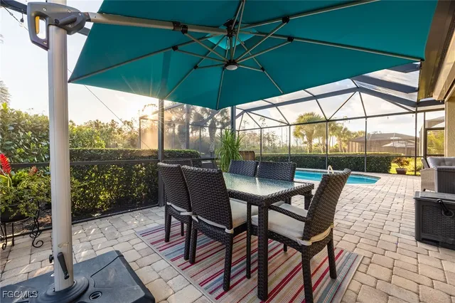 a living room with furniture kitchen view and a chandelier