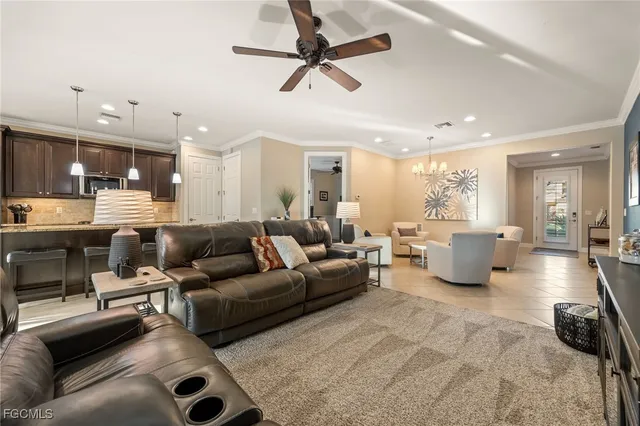 a kitchen with granite countertop a sink dining table and chairs