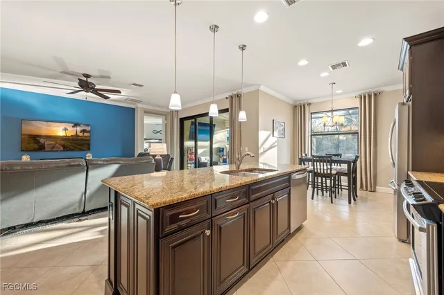 a kitchen with stainless steel appliances granite countertop a stove oven and a refrigerator