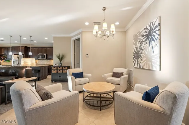 a living room with furniture and a chandelier