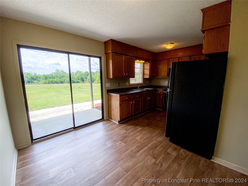 1829 Horne Camp Road, Unit 2 Fairmont, NC 28340 - Photo 6 of 18 a kitchen with stainless steel appliances granite countertop a refrigerator a sink a stove and wooden floor