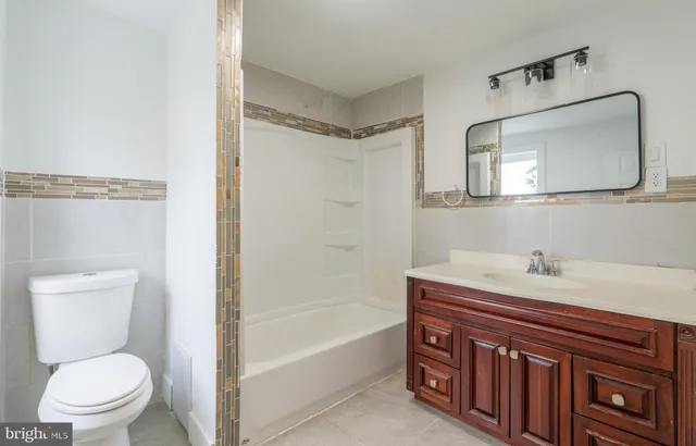 a bathroom with a sink a toilet and a bathtub