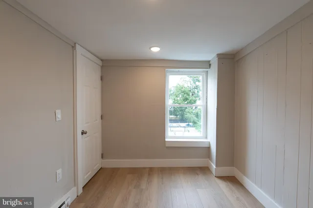 a view of room with window and wooden floor