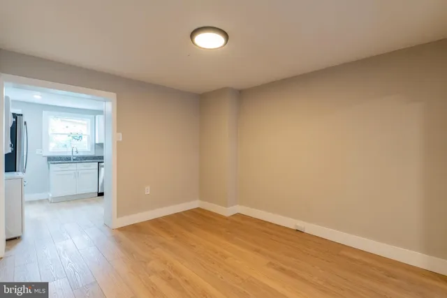 a view of a room with wooden floor and a sink