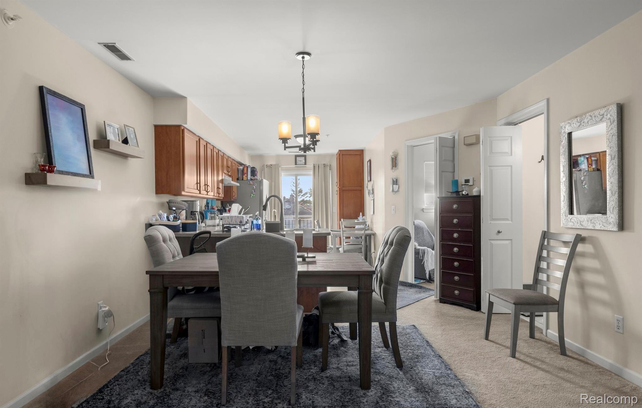4242 Schaefer Road Dearborn, MI 48126 - Photo 12 of 18 Dining room with a chandelier and light carpet