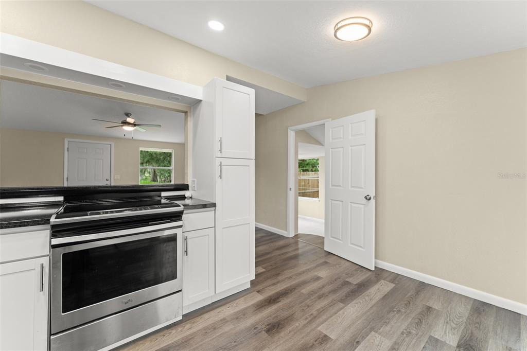 247 Toms Road DeBary, FL 32713 - Photo 11 of 31 a kitchen with granite countertop a stove and a refrigerator