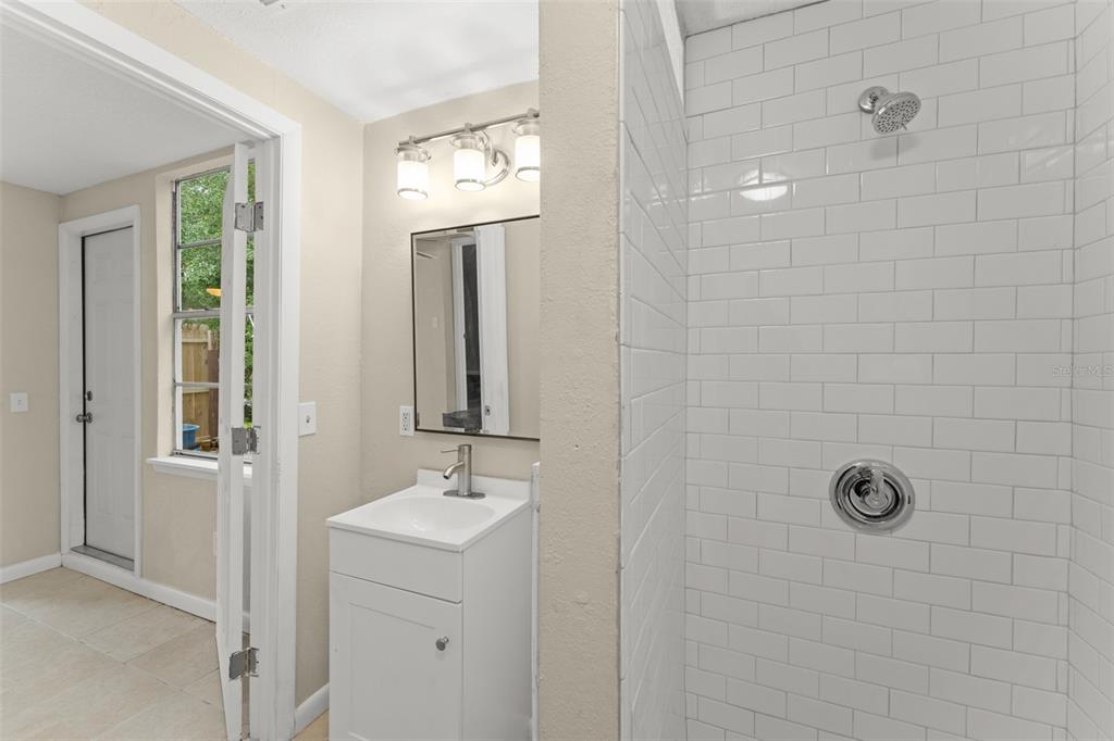 247 Toms Road DeBary, FL 32713 - Photo 15 of 31 a bathroom with a sink a mirror and shower