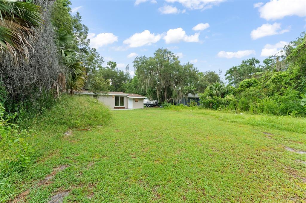 247 Toms Road DeBary, FL 32713 - Photo 29 of 31 a green field with lots of bushes