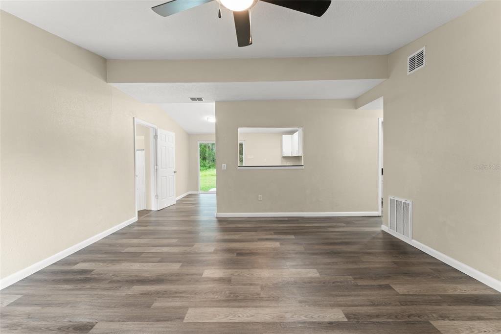 247 Toms Road DeBary, FL 32713 - Photo 3 of 31 a view of an empty room with window and wooden floor