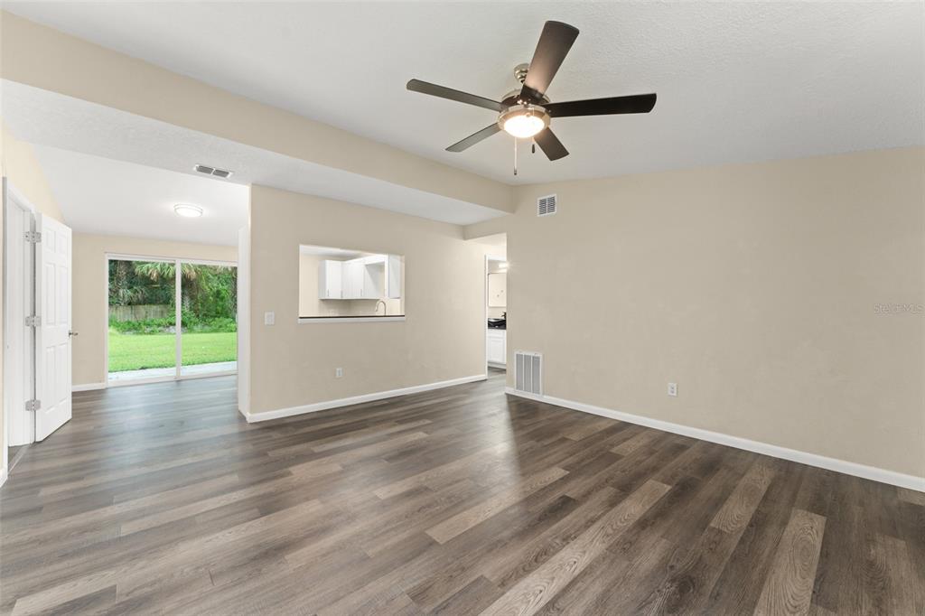 247 Toms Road DeBary, FL 32713 - Photo 5 of 31 a view of an empty room with wooden floor and a window