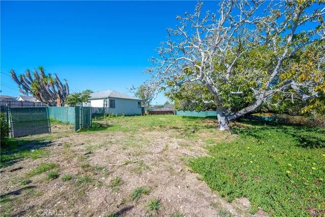 a yellow house with yard in front of it