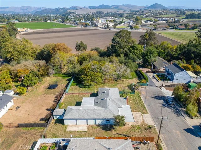 an aerial view of residential houses with outdoor space and river