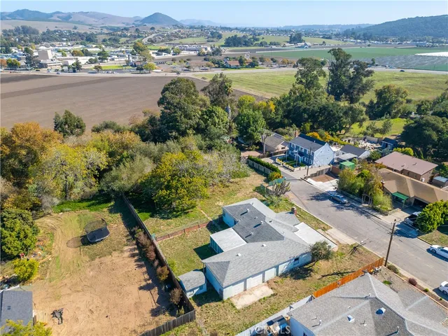 an aerial view of lake and residential houses with outdoor space