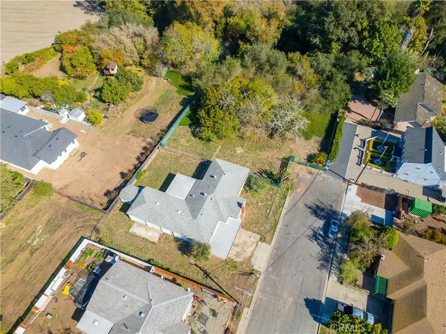 an aerial view of a house with a yard and lake view
