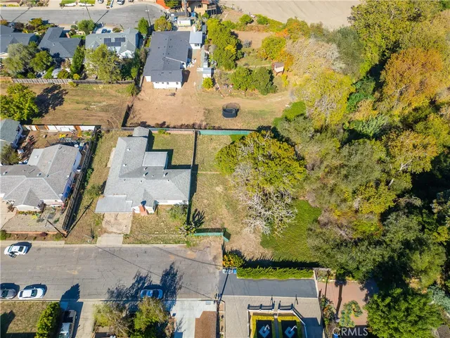 an aerial view of a house with a yard basket ball court and outdoor seating