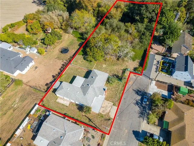 an aerial view of a house with a yard