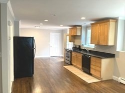 5 Shafter Street, Unit 1 Boston, MA 02121 - Photo 3 of 5 a kitchen with granite countertop a refrigerator and wooden cabinets