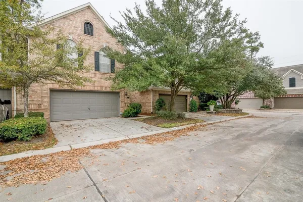 a view of a house with a yard and garage
