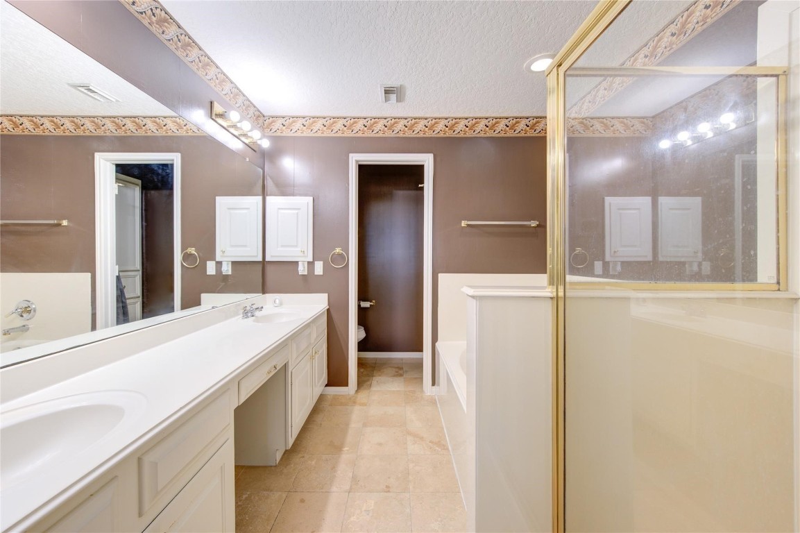 14420 Walters Road, Unit 58 Houston, TX 77014 - Photo 15 of 25 a bathroom with a double vanity sink mirror and shower