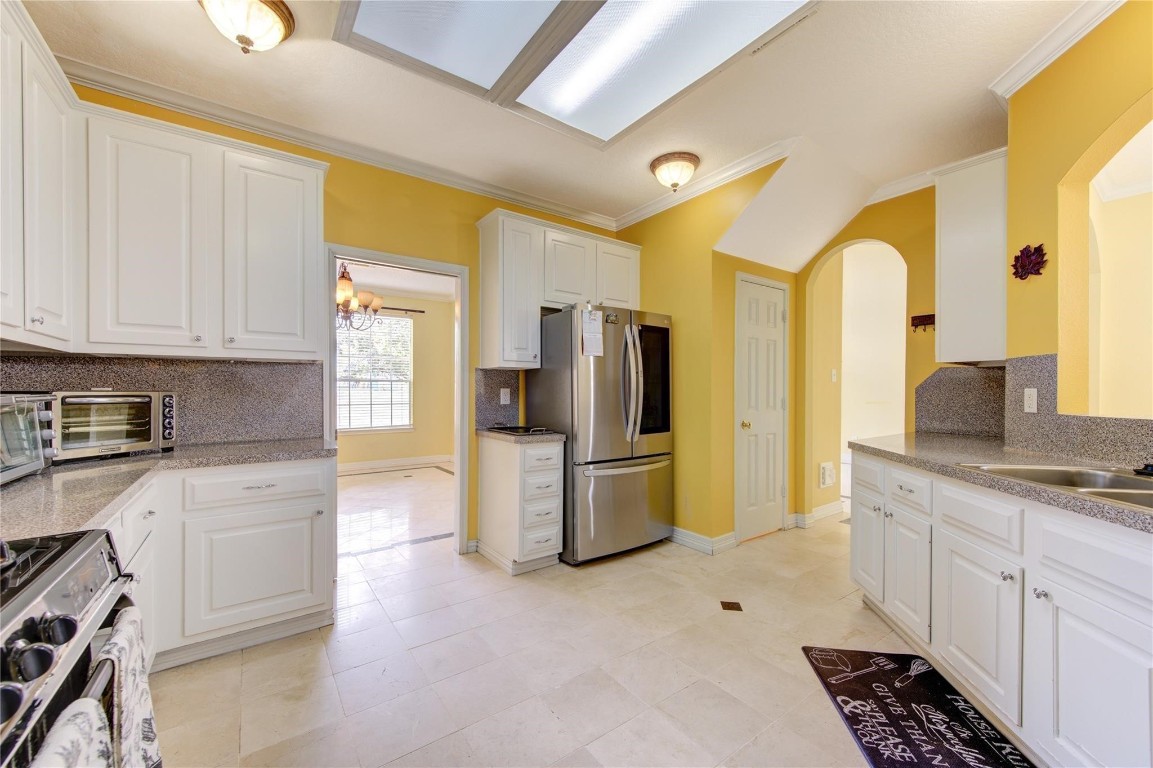 14420 Walters Road, Unit 58 Houston, TX 77014 - Photo 9 of 25 a kitchen with a refrigerator and a stove top oven