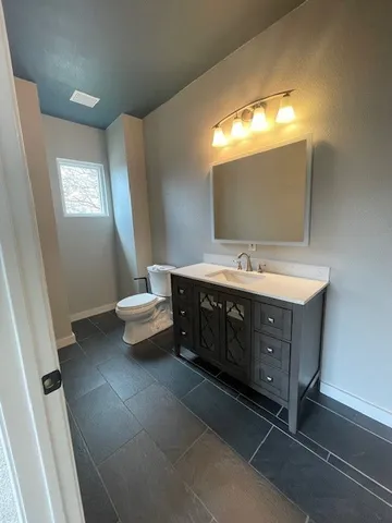 a spacious bathroom with a double vanity sink and a mirror