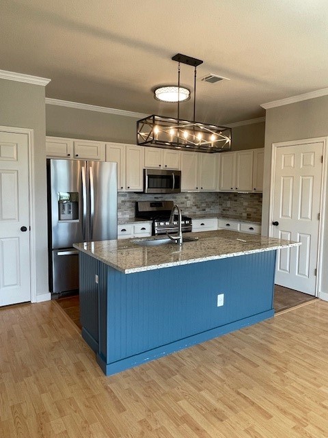 7501 Shadowridge Run, Unit 135 Austin, TX 78749 - Photo 5 of 23 a kitchen with stainless steel appliances granite countertop a stove refrigerator and microwave