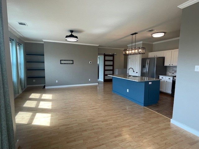 7501 Shadowridge Run, Unit 135 Austin, TX 78749 - Photo 7 of 23 a view of a kitchen with kitchen island a sink stainless steel appliances and cabinets