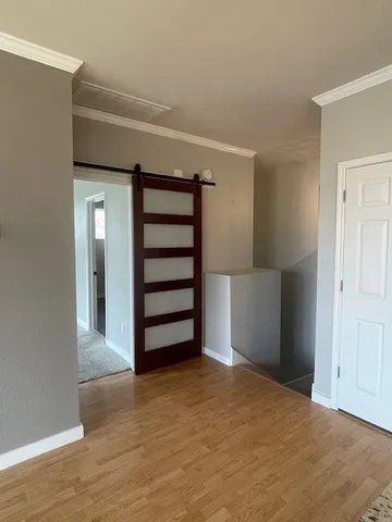 a view of empty room with stairs and closet