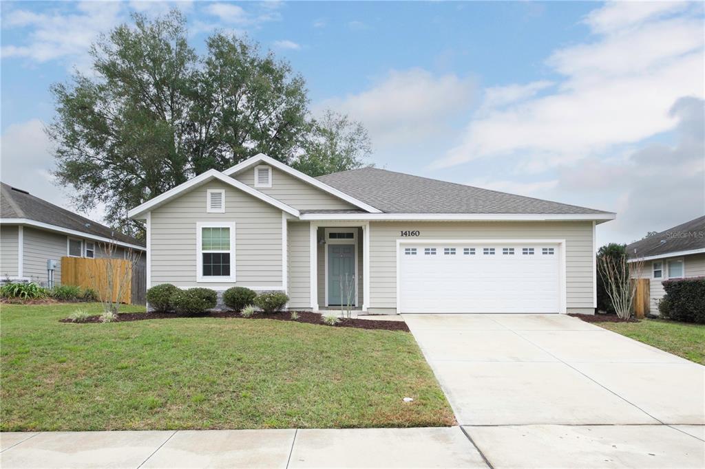 14160 Northwest 9th Road Newberry, FL 32669 - Photo 1 of 1 a view of a house with garage and garden